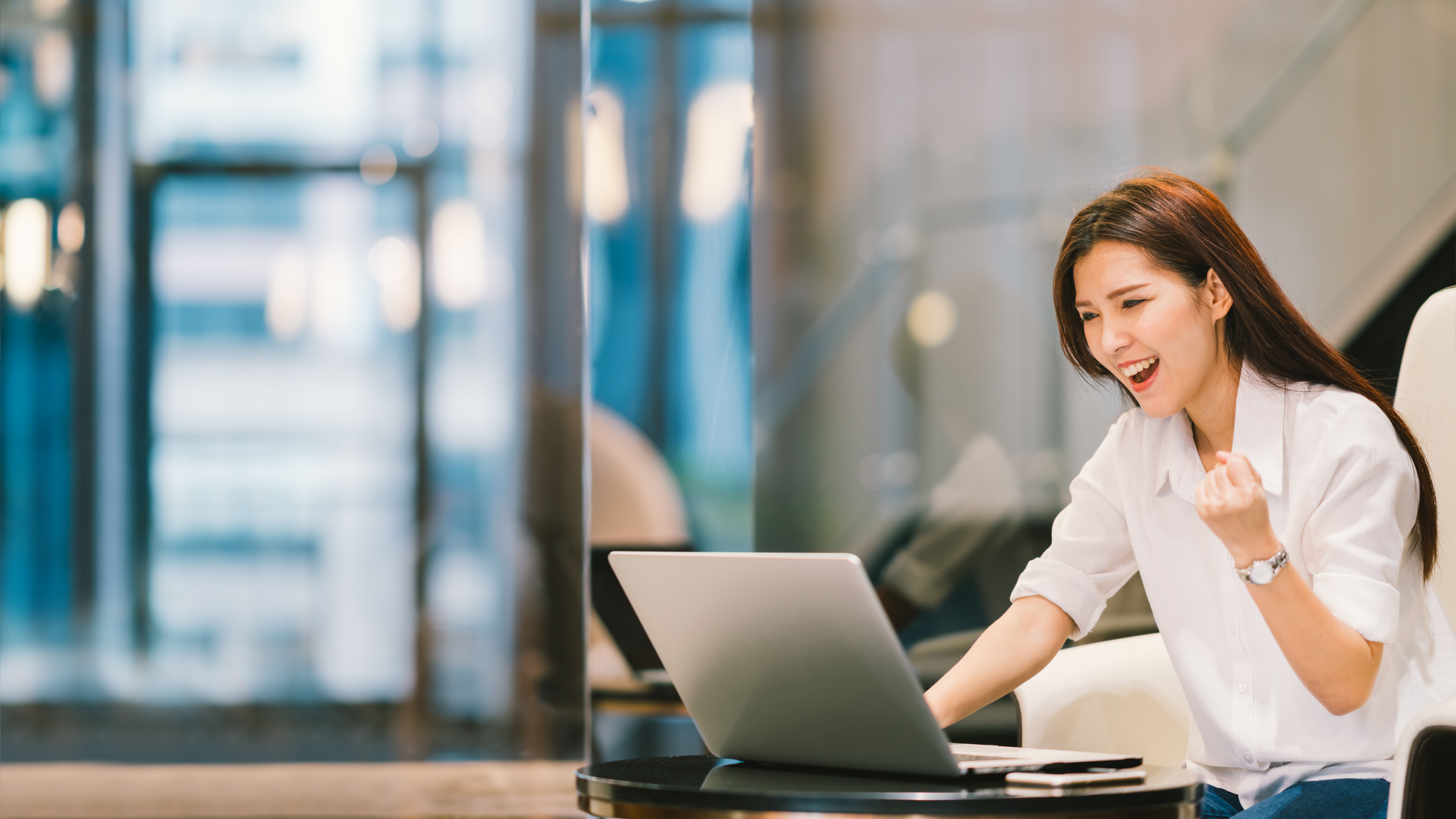 Beautiful Asian girl celebrate with laptop, success or happy pose, education or technology or startup business concept, modern office or living room with copy space