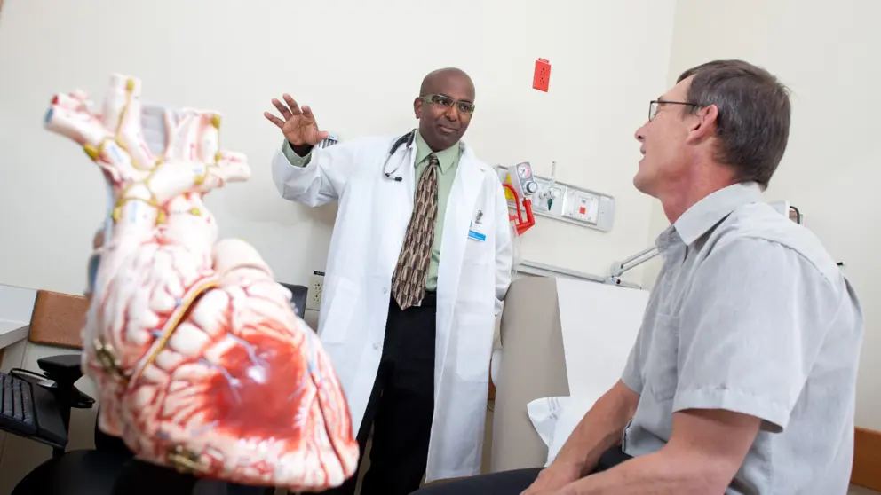 Dr. Gavin Oudit speaks with a patient.