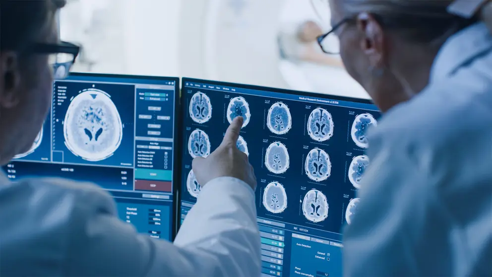 Two doctors studying brain scans