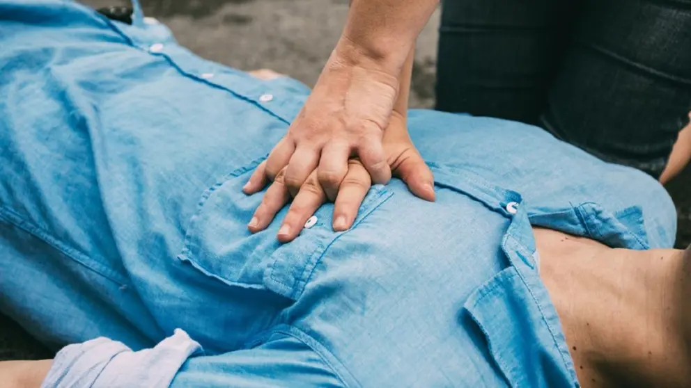 Hands doing CPR on a man’s chest