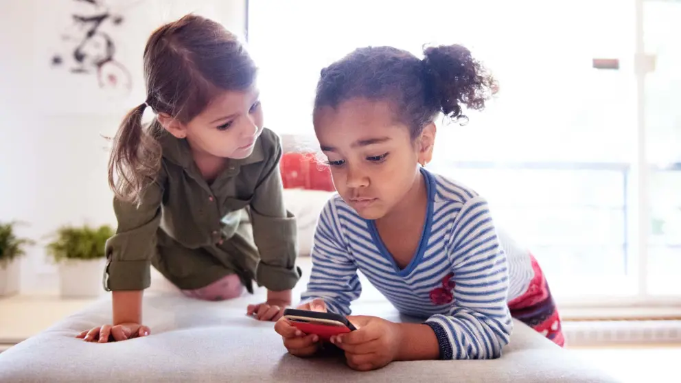 Two kids using a smartphone