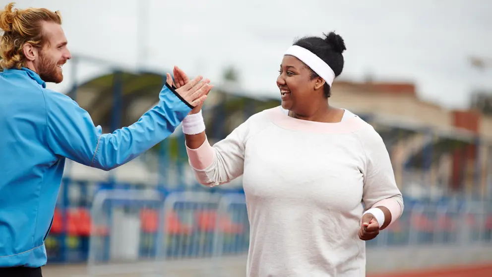 Woman giving her trainer a high five