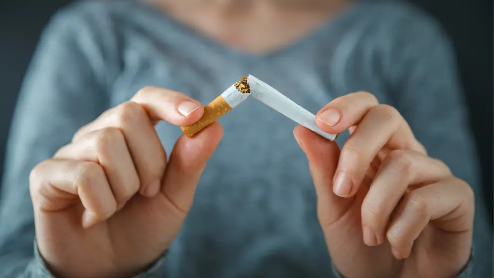 Closeup of a woman breaking a cigarette