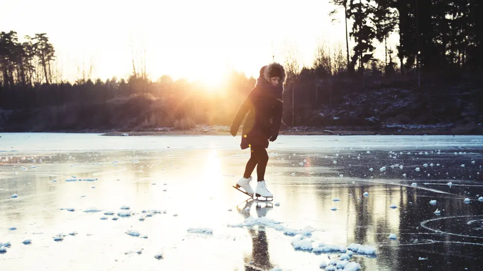 Girl skating on lake