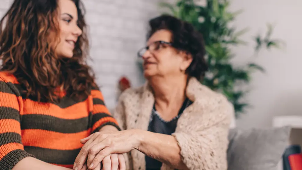 Mother and daughter sitting talking