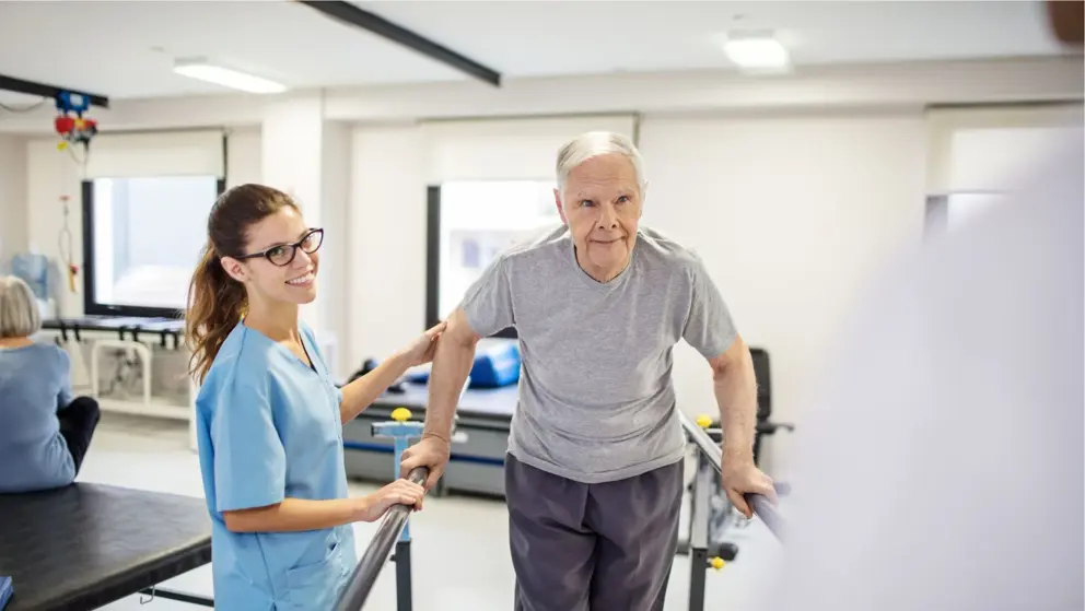  Nurse guiding patient to walk on slope in rehab