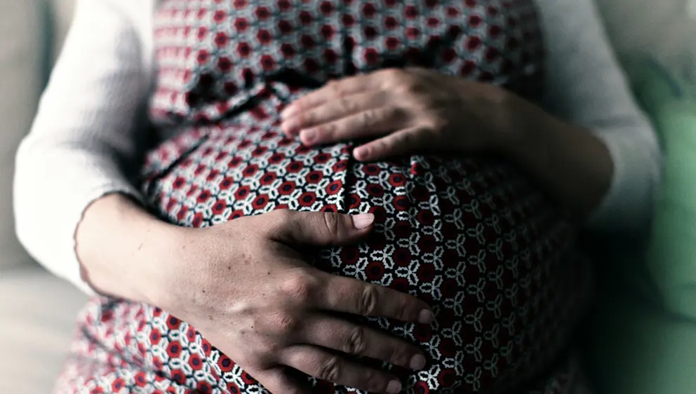 Pregnant woman holding her belly