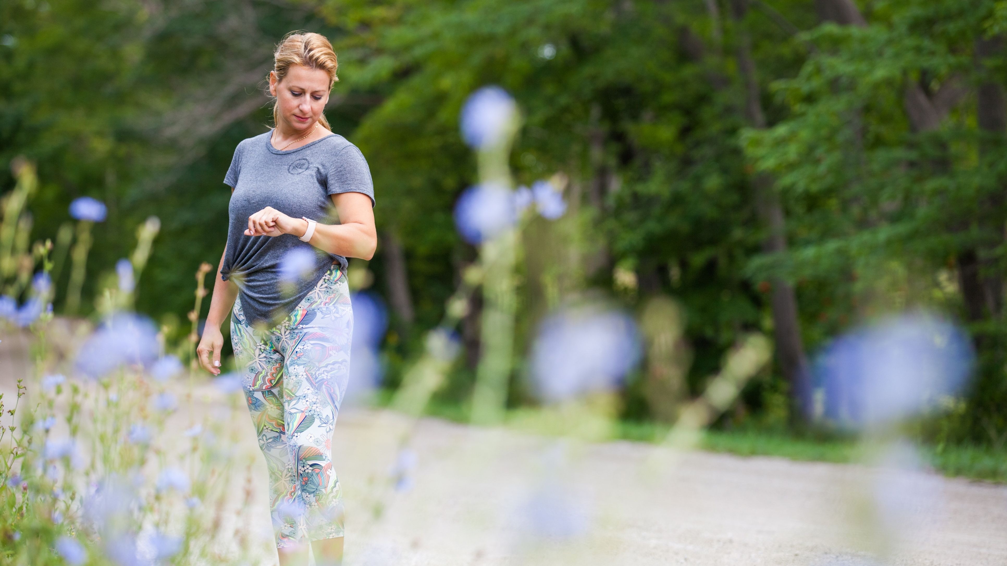 Woman exercising outdoors checking her fitness monitor