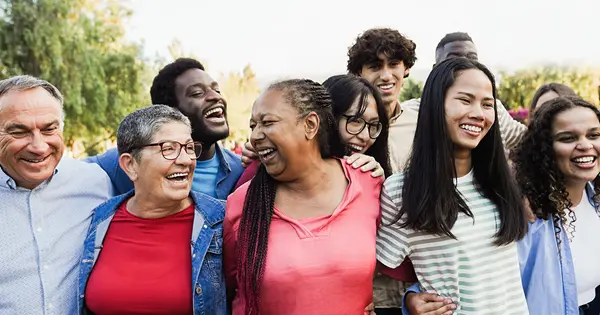 A diverse group of friends celebrating outdoors.