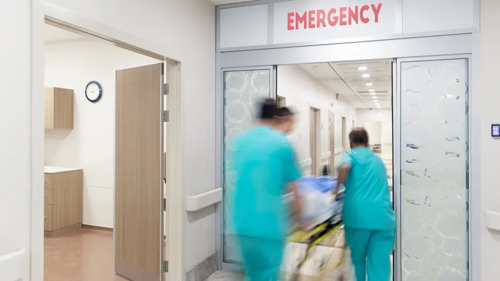 Doctors pushing patient on stretcher