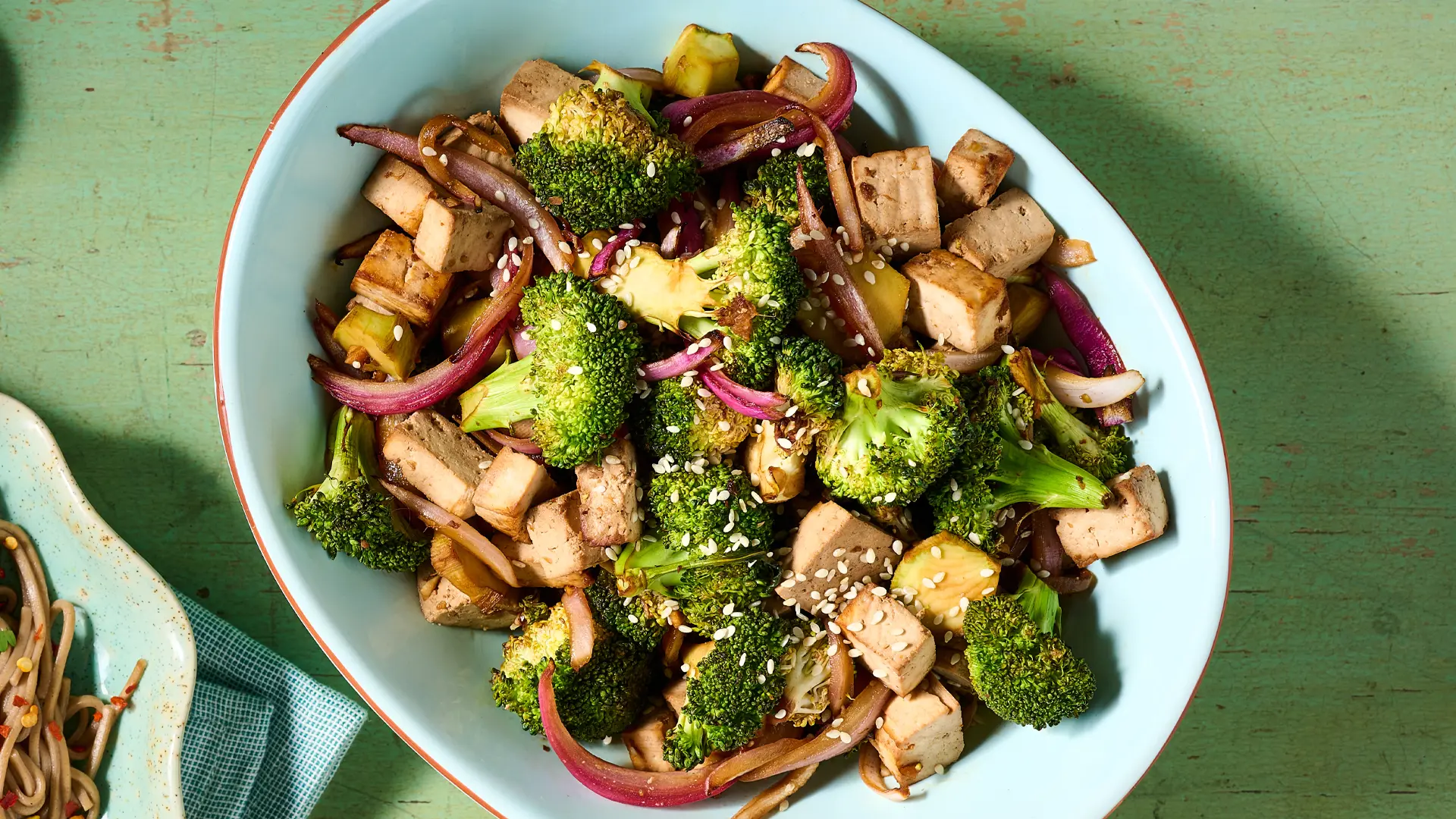 Tofu, broccoli and onion in a serving dish. 