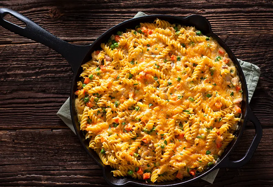 A pan with cooked mac & cheese and vegetables