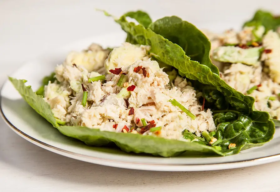 A plate with tuna salad wrapped in lettuce leaves